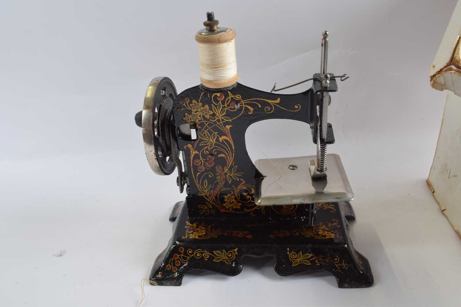 A childs German sewing machine with painted floral decoration in original box together with a - Image 2 of 2