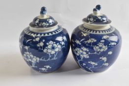 Two small Chinese porcelain ginger jars and covers the blue ground with prunus decoration and one