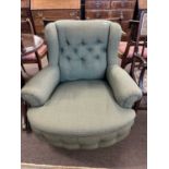 A good quality late 19th or early 20th Century deep seated armchair with green buttoned upholstery
