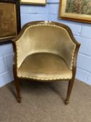 An Edwardian mushroom upholstered bow back chair raised on tapering legs with spade feet