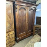 A Victorian mahogany wardrobe of large proportions with moulded cornice over two panelled doors