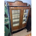 Edwardian mahogany and inlaid china display cabinet of bow front form with two lead glazed doors,