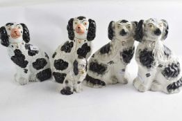 A group of five Staffordshire spaniels all with typical black sponged markings