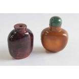 Two further snuff bottles glass with a mottled brown decoration, one with green stopper