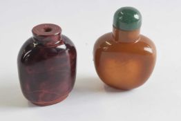 Two further snuff bottles glass with a mottled brown decoration, one with green stopper