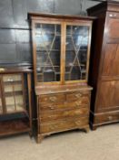 An 18th Century and later combination bookcase chest with two glazed doors over a base with two