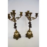 Pair of candleabra in French Empire style the four branch candleabra supported by a bronzed cherub