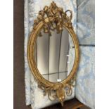 A 19th Century gilt framed girandole wall mirror with foliate shell moulding and swag detail,