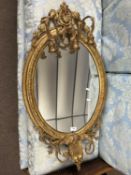 A 19th Century gilt framed girandole wall mirror with foliate shell moulding and swag detail,