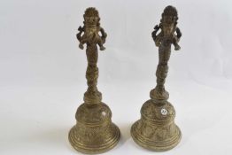 Two brass table or temple bells decorated with the Hindu Diety Ganesha, 22cm high
