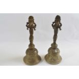 Two brass table or temple bells decorated with the Hindu Diety Ganesha, 22cm high