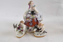 A continental porcelain figure of a flower seller and two putti with goats