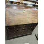 A Georgian mahogany bureau of typical form with full front opening to an interior with small