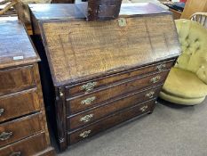 A Georgian oak and mahogany cross banded bureau with full front opening to a interior with small
