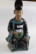 A Chinese pottery terracotta figure of a seated official holding a Ruyi in one hand, 40cm high