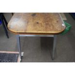 A 20th Century industrial style metal framed dining table with pine top together with two