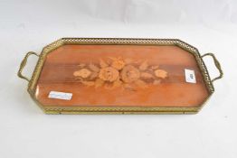 A small wooden tray with floral inlay and brass rail