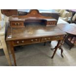 An Edwardian mahogany and inlaid writing table with an arched back with shelf and two small