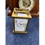 An early 20th Century brass carriage clock, the white enamel dial marked Dent, Pall Mall, London