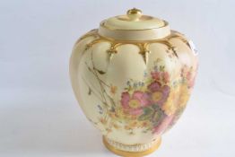 A Royal Worcester blush ground vase and cover of globular form painted with flowers