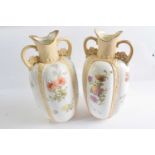 A pair of late 19th Century Doulton Burslem vases of lobed shape painted with panels of flowers,