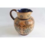 A large late 19th Century Doulton stone ware jug with decoration of flowers on a buff ground, 21cm