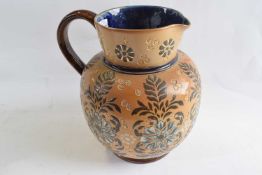 A large late 19th Century Doulton stone ware jug with decoration of flowers on a buff ground, 21cm