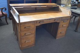 Early 20th Century oak roll top desk with twin pedestals, drop down side leaf, the lock plate