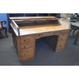 Early 20th Century oak roll top desk with twin pedestals, drop down side leaf, the lock plate