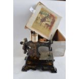 A childs German sewing machine with painted floral decoration in original box together with a