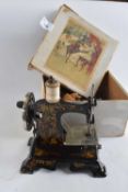 A childs German sewing machine with painted floral decoration in original box together with a