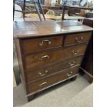 A Georgian chest with two short over three long drawers fitted with brass swan neck handles and