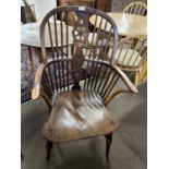 A 19th Century yew and elm Windsor chair with central wheel formed splat and stick back raised on