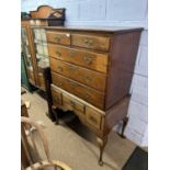 A George III oak chest on stand, the top section with two short over three long drawers, the base