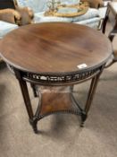 A Chippendale style circular top occasional table with pierced freize and legs formed as three