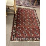 20th Century Middle Eastern wool floor rug decorated with a central panel of octagonal lozenges on a
