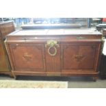 A large French Empire style sideboard with two concave fronted drawers over two doors set with