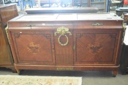 A large French Empire style sideboard with two concave fronted drawers over two doors set with