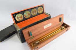 A boxed collection of lantern slides and measuring instrument marked G Thornton Ltd, Manchester,