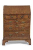A small Queen Anne and later walnut ladies bureau with fall flap, fitted interior over two short and