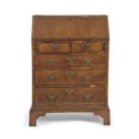 A small Queen Anne and later walnut ladies bureau with fall flap, fitted interior over two short and