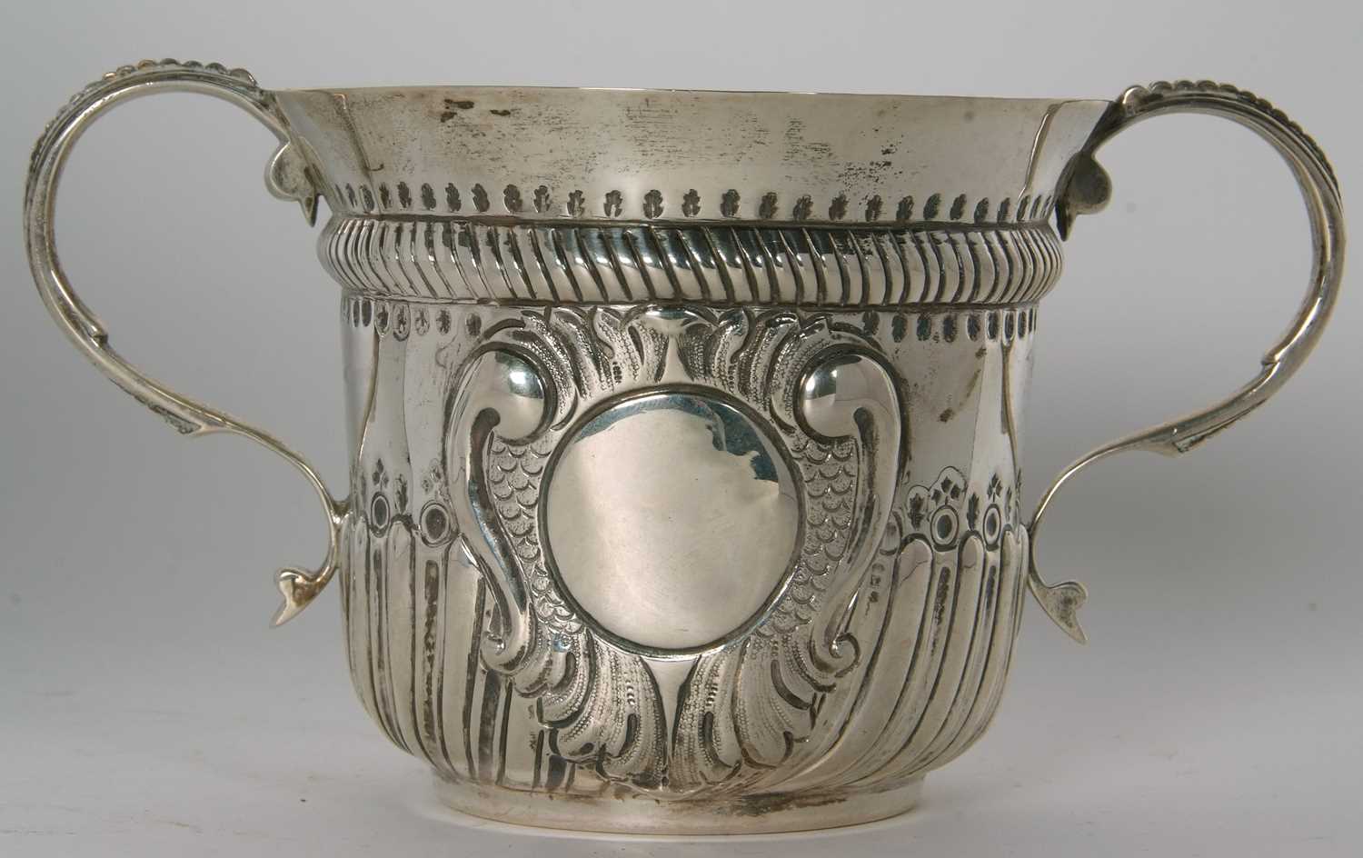 An early 20th Century copy of a George I loving cup, having two beaded scrolled handles, wrythen - Image 3 of 36