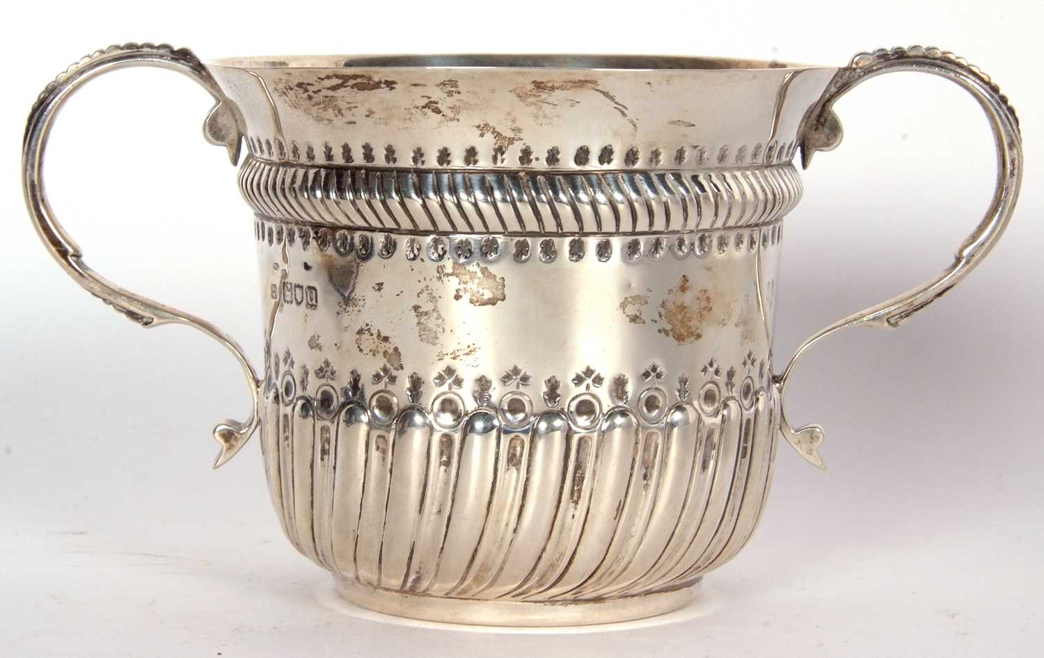 An early 20th Century copy of a George I loving cup, having two beaded scrolled handles, wrythen - Image 14 of 36