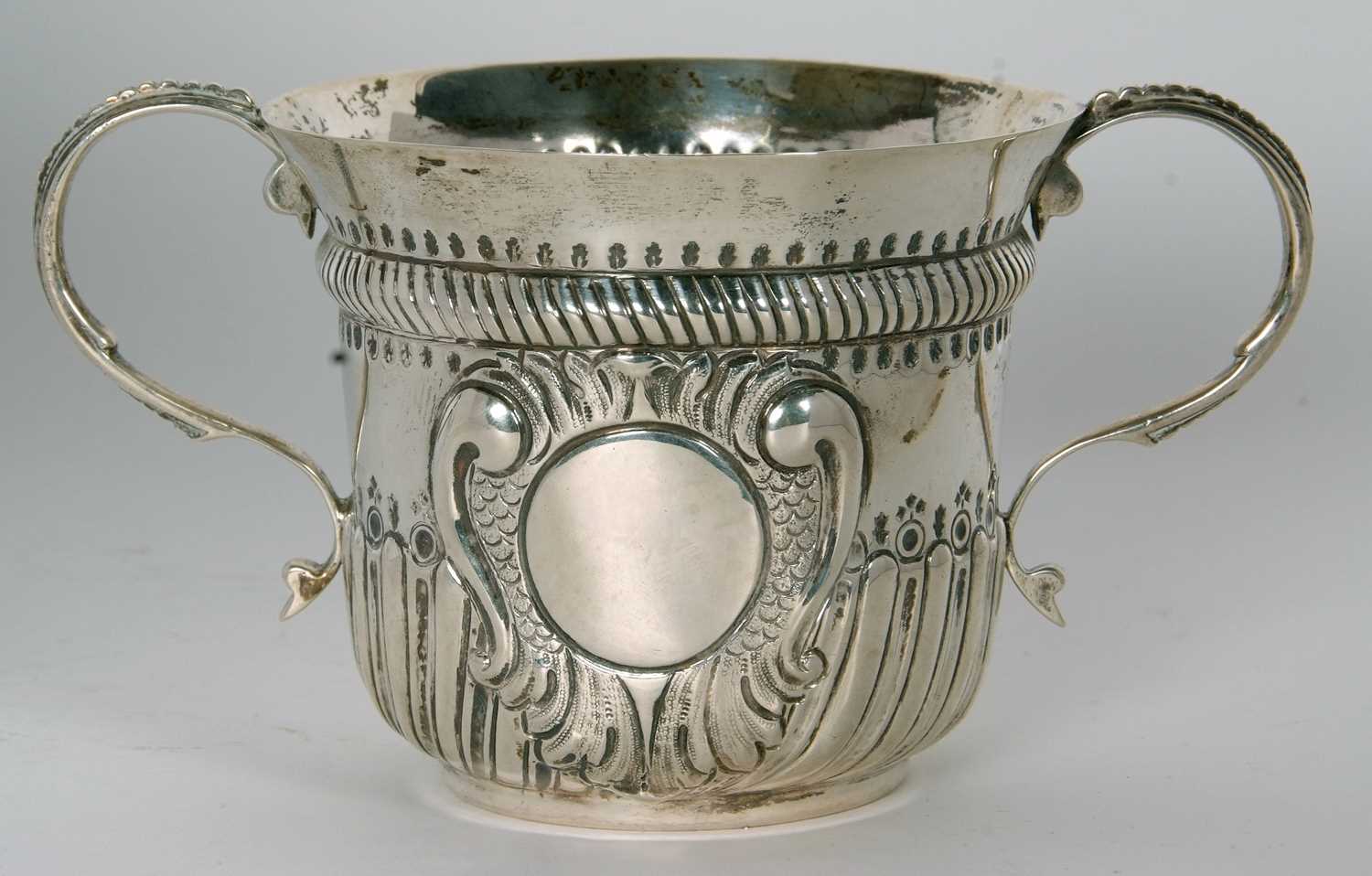 An early 20th Century copy of a George I loving cup, having two beaded scrolled handles, wrythen - Image 2 of 36