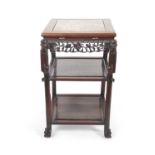 A Chinese hardwood and marble inset three tier occasional table or plant stand with pierced carved