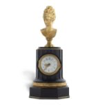 An unusual 19th Century French mantel clock of column form set with a gilt metal bust over a