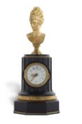 An unusual 19th Century French mantel clock of column form set with a gilt metal bust over a