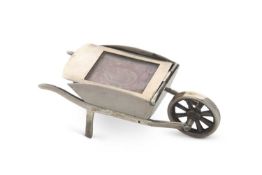 An Edwardian novelty stamp holder in the form of a wheelbarrow, plain polished form bearing