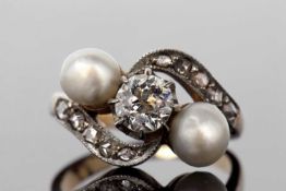 Diamond and pearl crossover ring featuring a round old cut diamond 0.30ct approx, and two pearls set