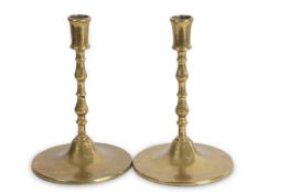 A pair of large Flemish brass candlesticks with knopped stems and spreading circular bases reputedly